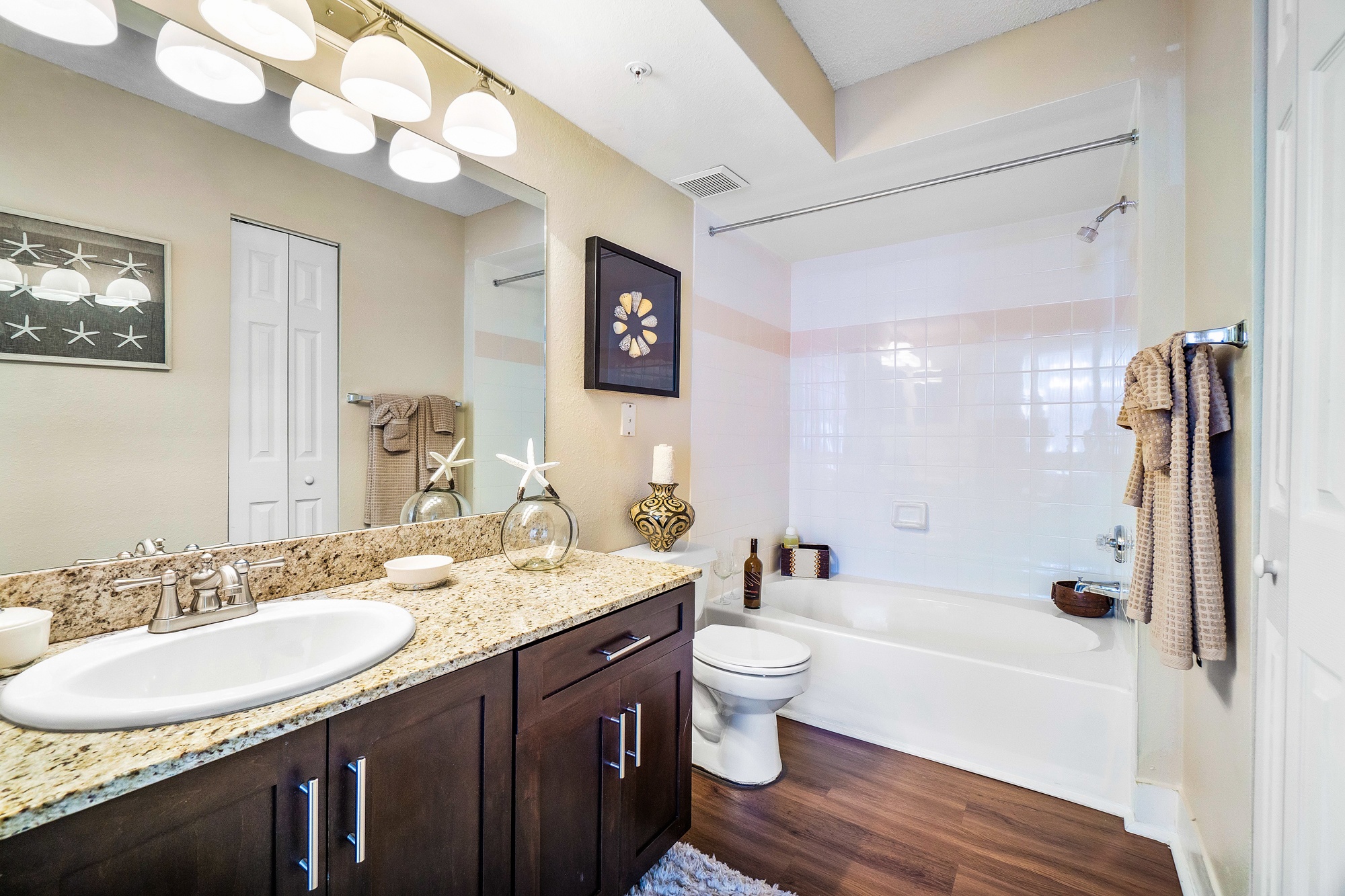 A bathroom with a white sink and a white toilet.